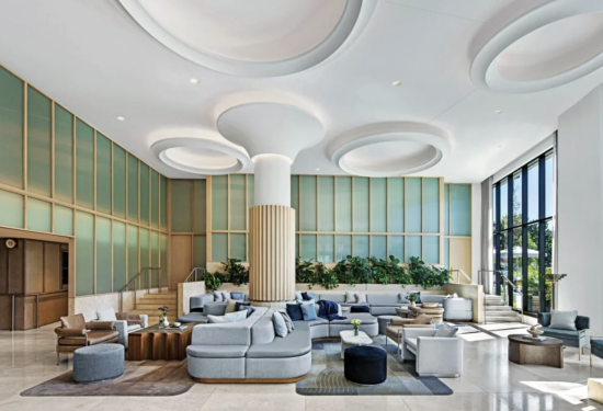 Modern five-star hotel with sleek architecture, illuminated at dusk.