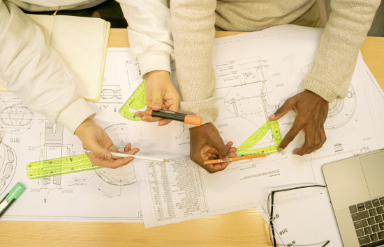 Owners Rep discussing construction plans with PMC team members on site