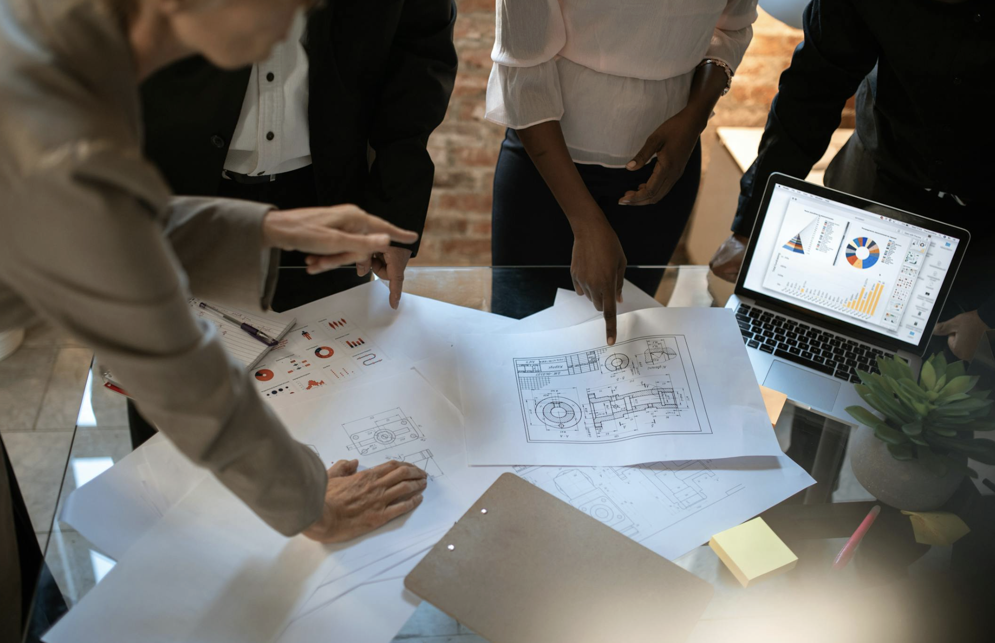 Construction project management team reviewing project progress on digital dashboard in modern office